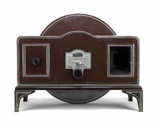 Figure 1 — A genuine Baird Televisor, manufactured by the Plessey Company circa 1930, photographed for its Bonhams sale — the chocolate-brown tinplate case, the disc visible edge-on behind the cabinet, and th…