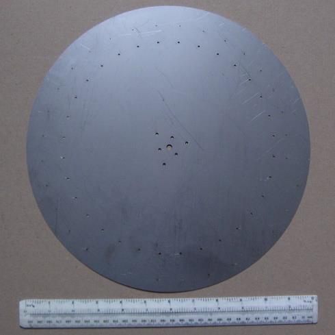 Figure 3 — A modern, laser-cut stainless-steel 12-inch Nipkow disc, photographed for the NBTVA's own Club Sales price list — real, current stock a club member can buy today for £11.00. This is the honest mode…