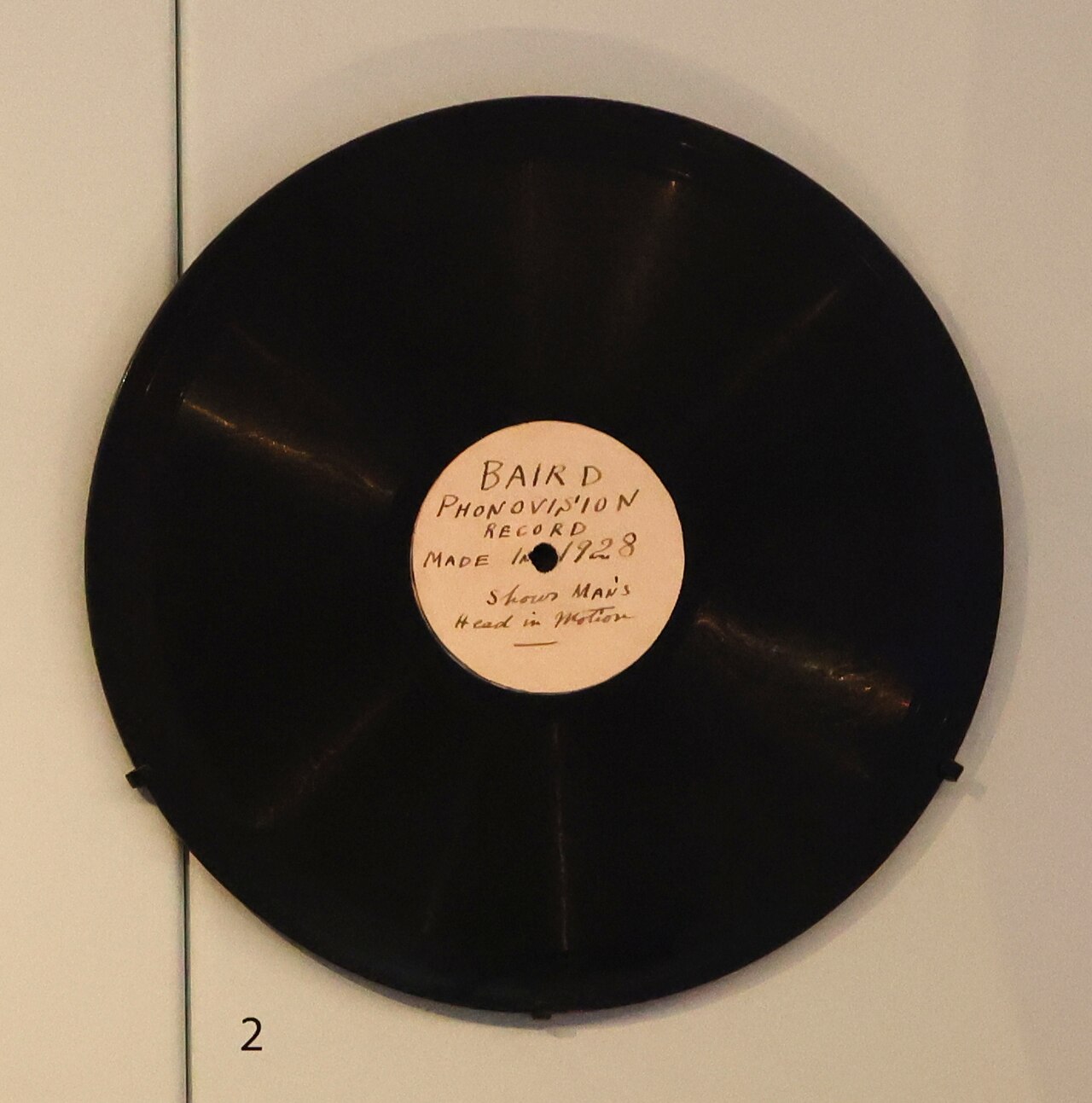 Figure 2 — A surviving Phonovision disc from 1928, showing the fine spiral groove into which the audio-bandwidth television signal was cut at 78 rpm. The disc is physically indistinguishable from a gramophone…